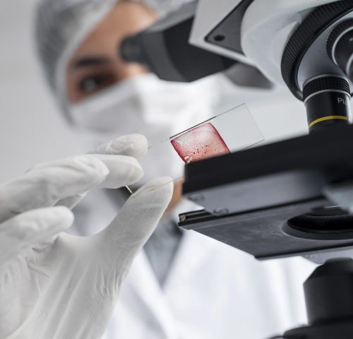 close-up-blurry-scientist-working-with-glass-slide